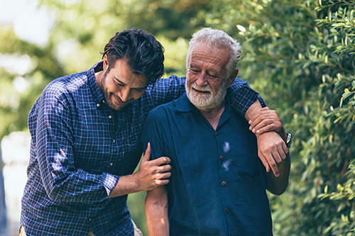 Father and son celebrating the father's retirement and the achievement of his IRA savings goal.